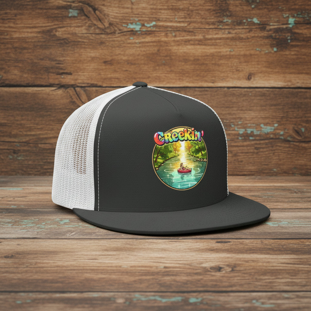 Snap-Back Trucker hat Black on White with Colorful Creekin' logo on the front.  Mesh back hat.  Old rustic wood background