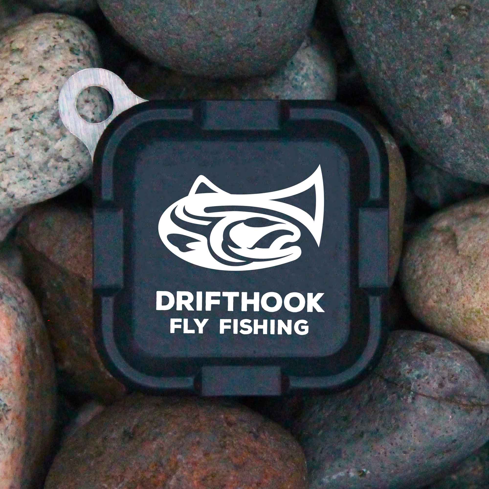 Drifthook Fly Fishing logo on a black square background surrounded by stones