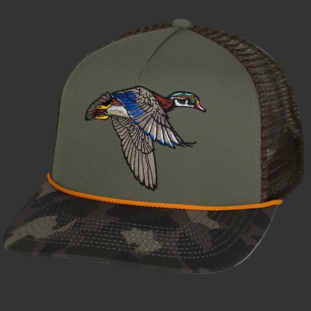 Flying Wood Duck Trucker Hat | Detailed Wing Spread Embroidery on Sage Green Crown with Dark Camo Brim — Clear Water Trading Co.