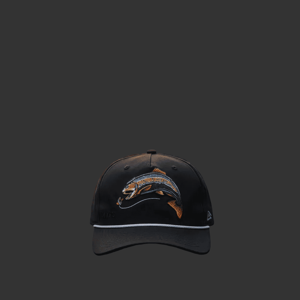 A black baseball cap featuring a colorful embroidered trout design on the front and a white piping accent along the edge of the brim, set against a solid dark gray background.