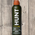 HUNT refined repellent bottle on a wooden background